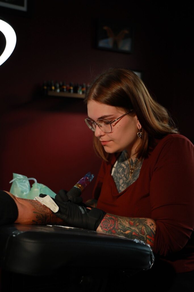 Portrait of tattoo artist Amber, owner of Moonchild, participating in the Sint-Niklaas Tattoo Expo.