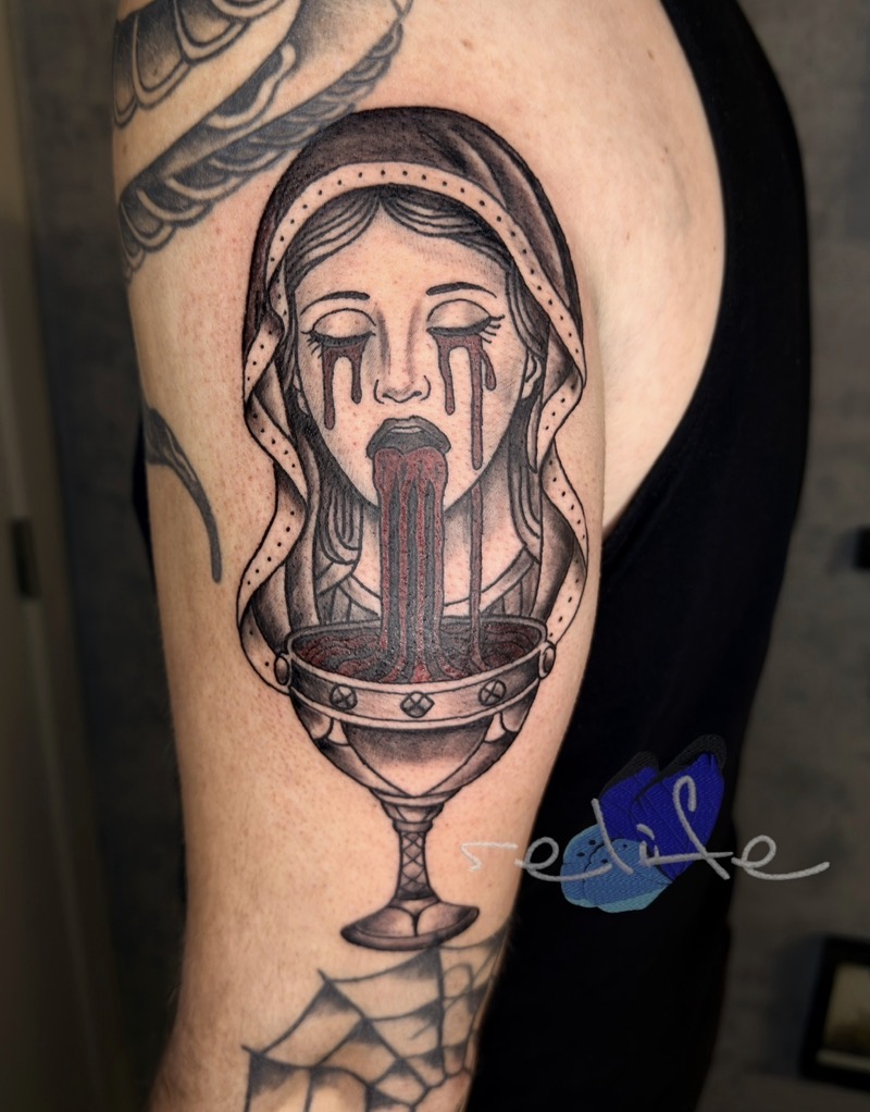 A dark, illustrative tattoo on an arm by Remi of Relife Tattoo. The piece shows a veiled woman with her eyes closed and a dark fluid streaming from her eyes and mouth into an ornate chalice, rendered with fine lines and deep shading.